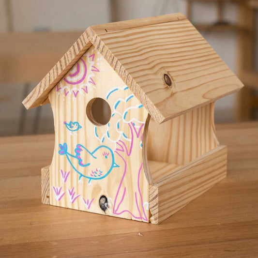 Finished wooden birdhouse from The Makers Society kids woodworking kit with hand-decorated details