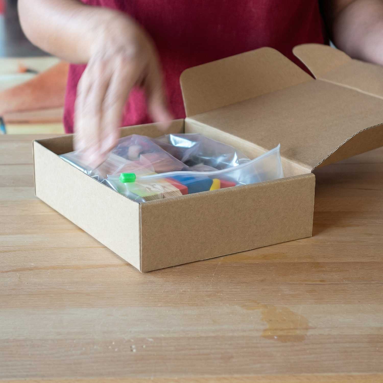 Opening The Makers Society kids woodworking kit box with all included materials inside