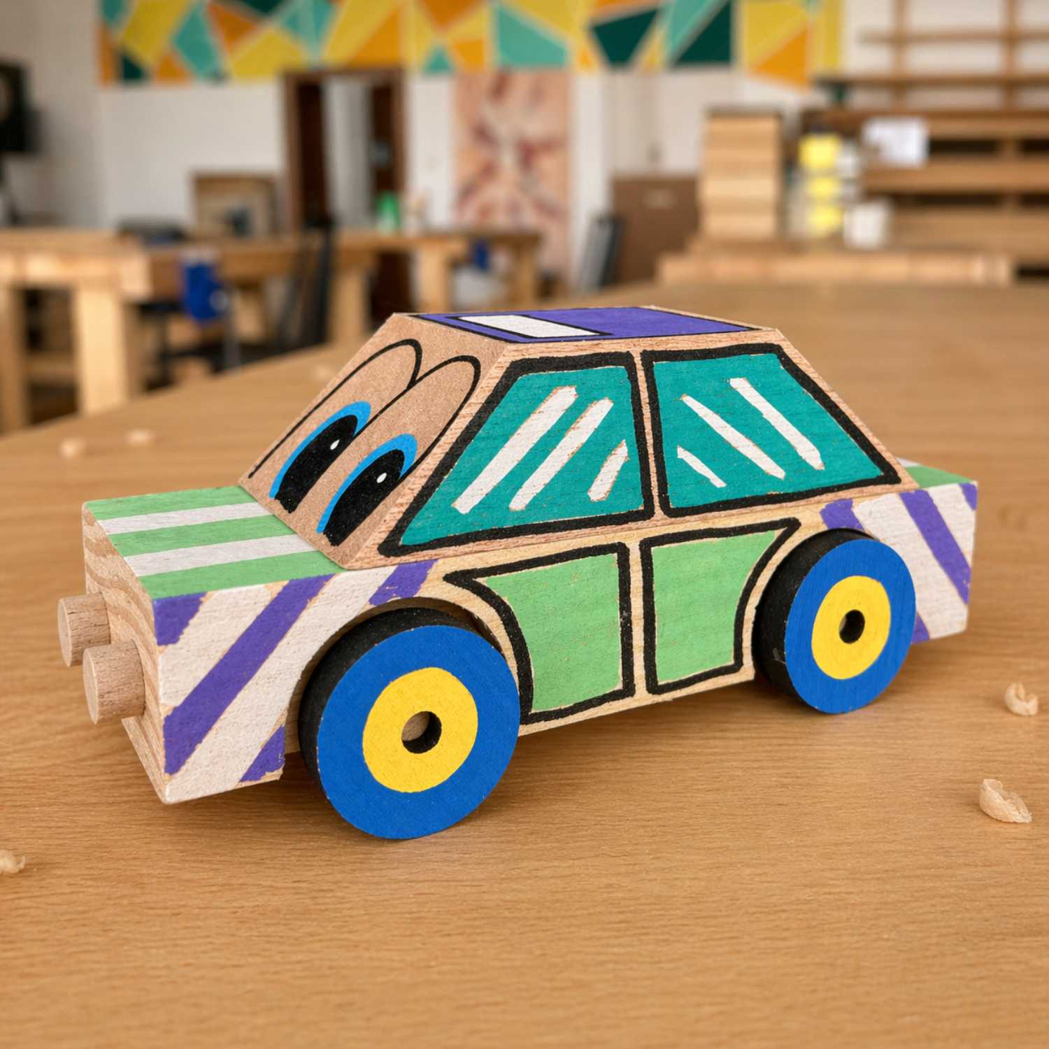 Finished wooden taxi car kit by The Makers Society in a side view showing the painted body, windows, and wheels.