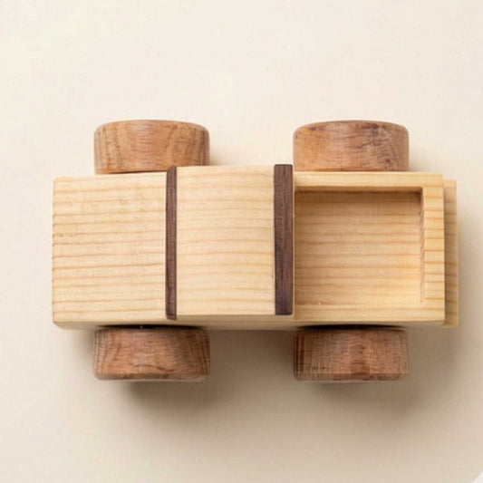 A minimalist top-down view of the wooden toy truck showing the truck bed construction and symmetrical wheel alignment.